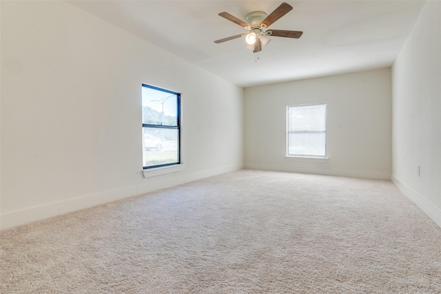 carpeted empty room featuring ceiling fan