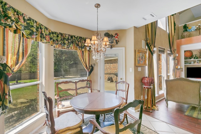 dining space with tile patterned floors and a chandelier