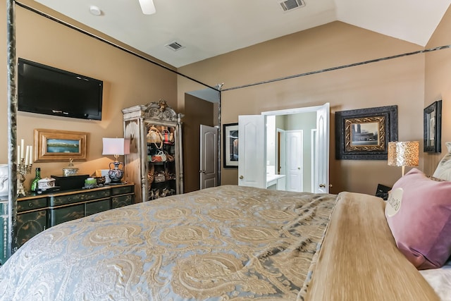 bedroom featuring lofted ceiling and ensuite bathroom