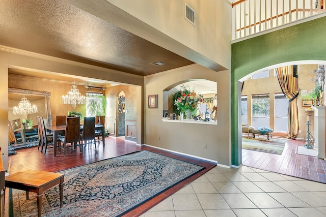 interior space with ornamental molding, a chandelier, and plenty of natural light