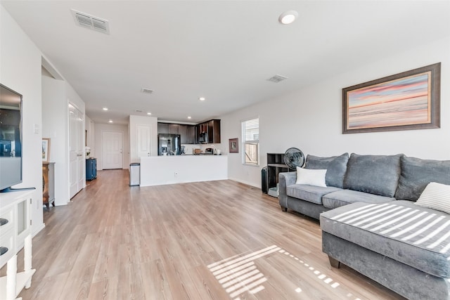 living room with light hardwood / wood-style floors