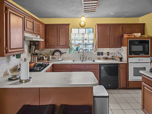 kitchen with sink, a textured ceiling, light tile patterned floors, decorative backsplash, and black appliances