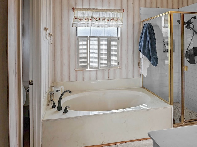 bathroom featuring separate shower and tub