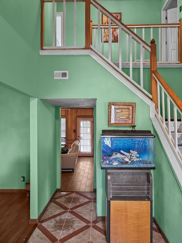 staircase with a towering ceiling