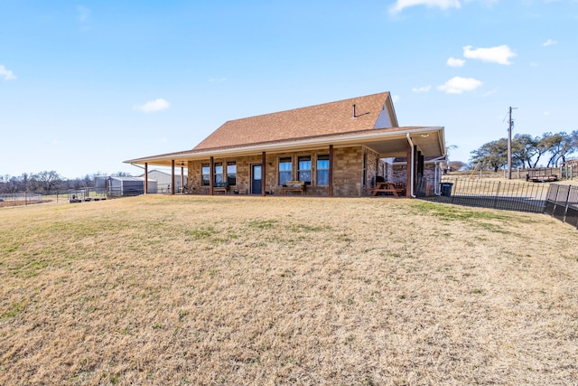 rear view of house with a yard