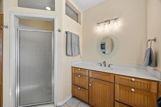 bathroom featuring vanity, a shower with shower door, and tile patterned flooring