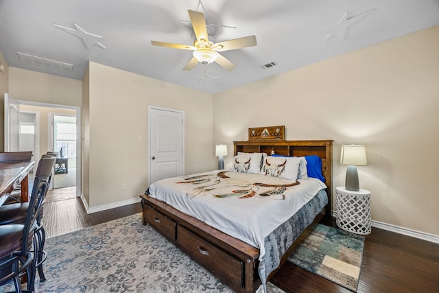 bedroom with ceiling fan and dark hardwood / wood-style floors