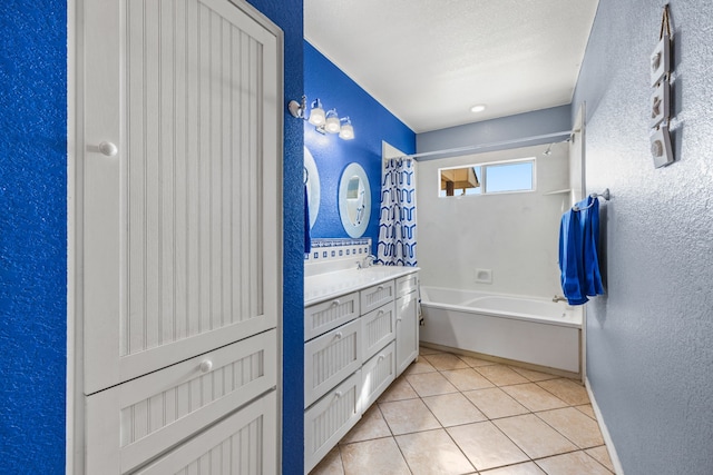 bathroom with tile patterned floors, plus walk in shower, vanity, and a textured ceiling