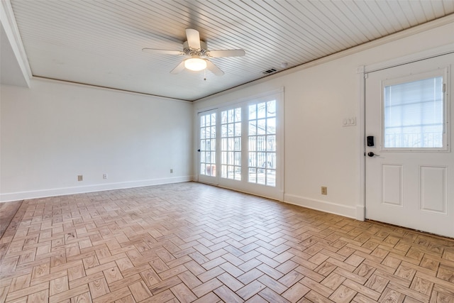 foyer entrance featuring crown molding, ceiling fan, and light parquet floors