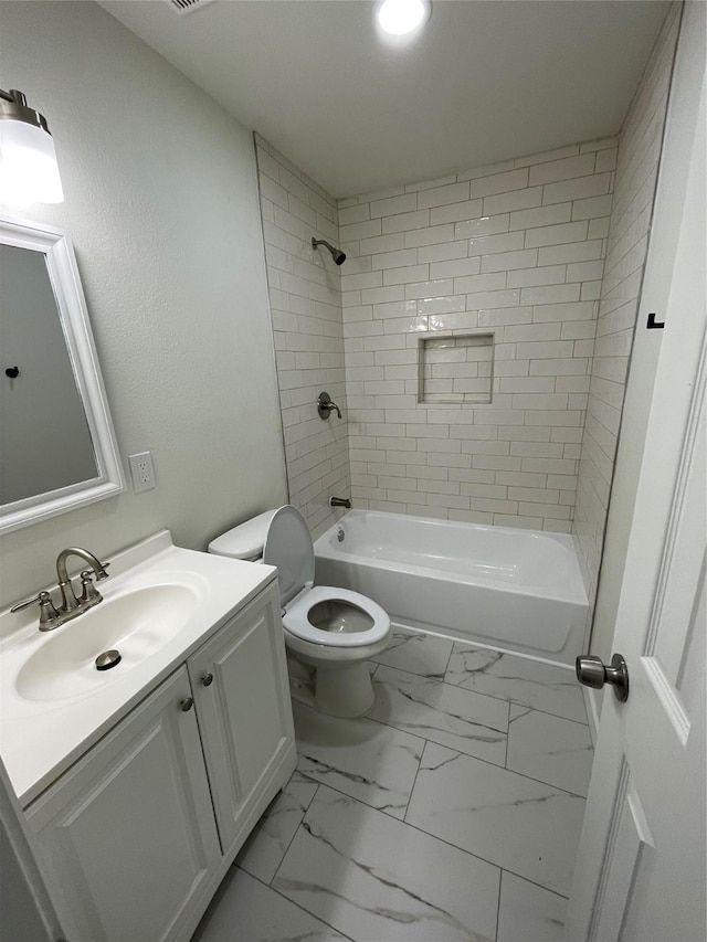 full bathroom featuring tiled shower / bath combo, vanity, and toilet