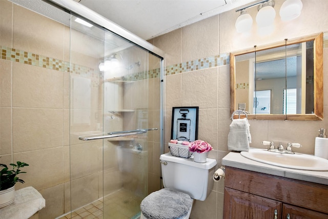 bathroom featuring tile walls, an enclosed shower, vanity, and toilet