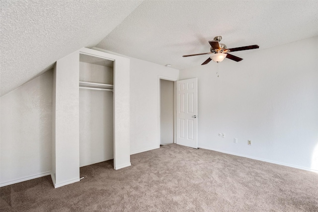 unfurnished bedroom featuring ceiling fan, carpet flooring, a closet, and a textured ceiling