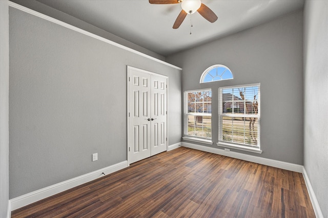 spare room featuring dark wood-type flooring and ceiling fan