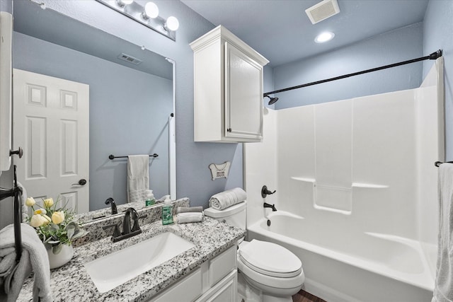 full bathroom featuring vanity, bathing tub / shower combination, and toilet