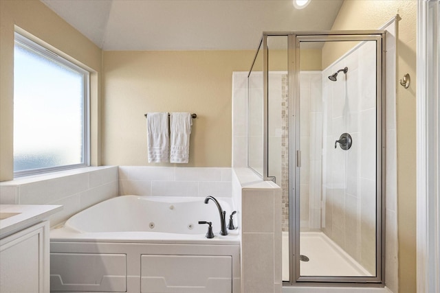 bathroom featuring shower with separate bathtub and vanity