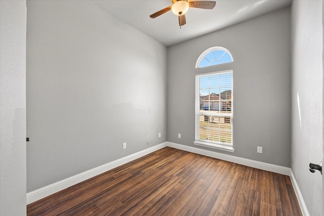 spare room with dark hardwood / wood-style floors and ceiling fan