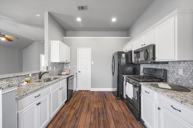 kitchen featuring white cabinetry, light stone countertops, sink, and black appliances