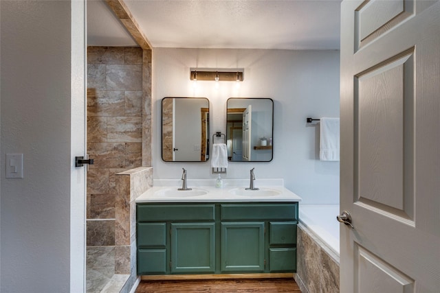 bathroom with independent shower and bath, vanity, and hardwood / wood-style floors