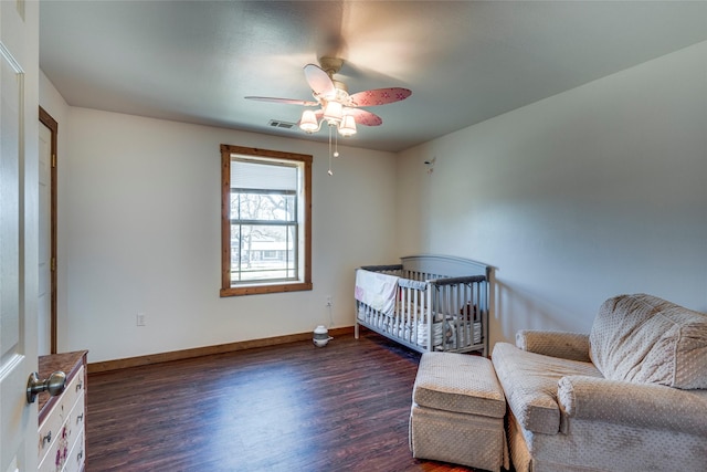 bedroom with ceiling fan and dark hardwood / wood-style flooring