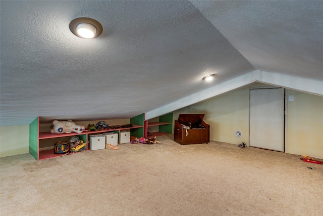 game room featuring carpet floors, vaulted ceiling, and a textured ceiling