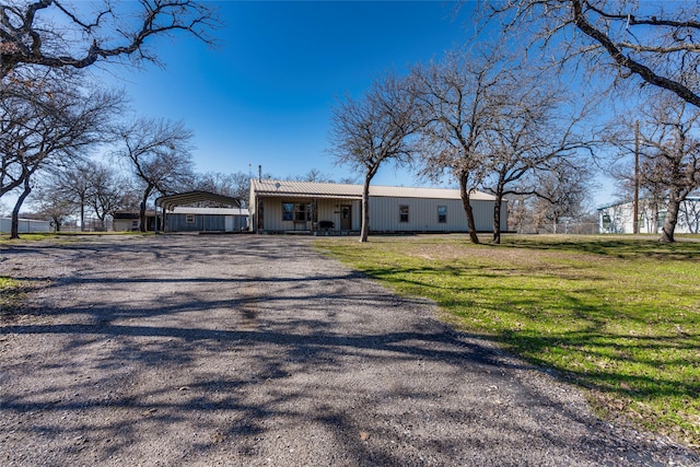 ranch-style house with a front lawn and a carport