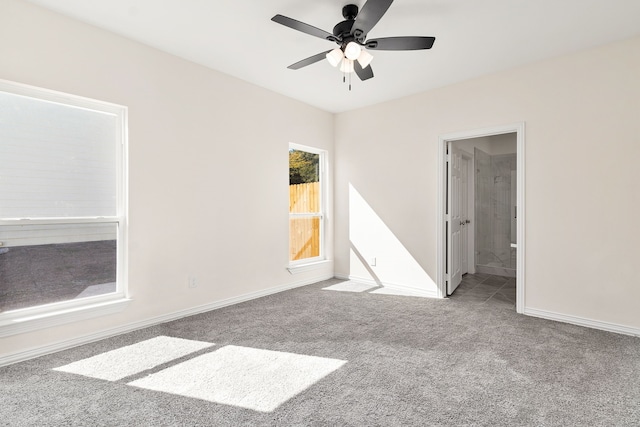 empty room with ceiling fan and carpet