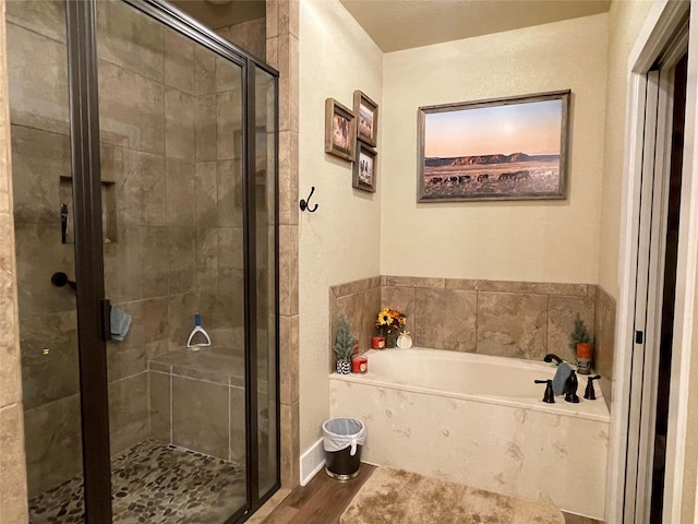 bathroom featuring hardwood / wood-style flooring and separate shower and tub