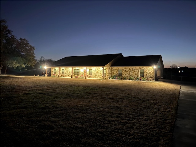 view of back house at dusk