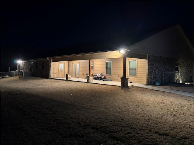 back house at night with a patio