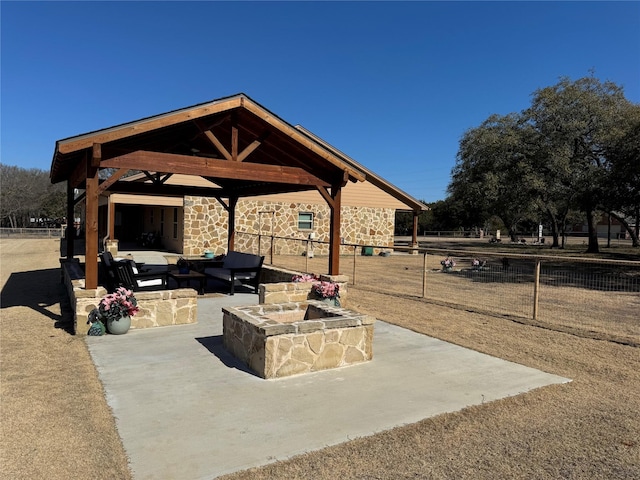 view of patio / terrace with a gazebo and an outdoor living space with a fire pit