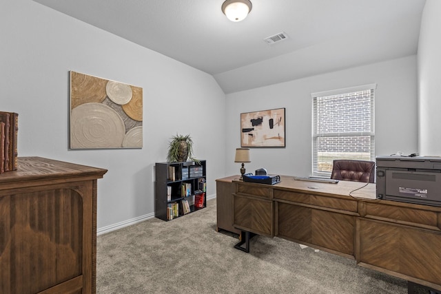 office area featuring lofted ceiling and light colored carpet