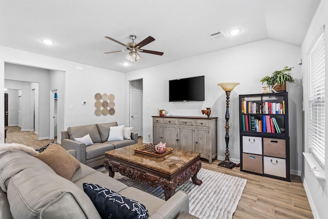 living room featuring light hardwood / wood-style flooring, ceiling fan, and vaulted ceiling