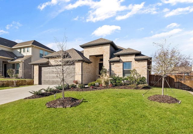 prairie-style house with a garage and a front lawn