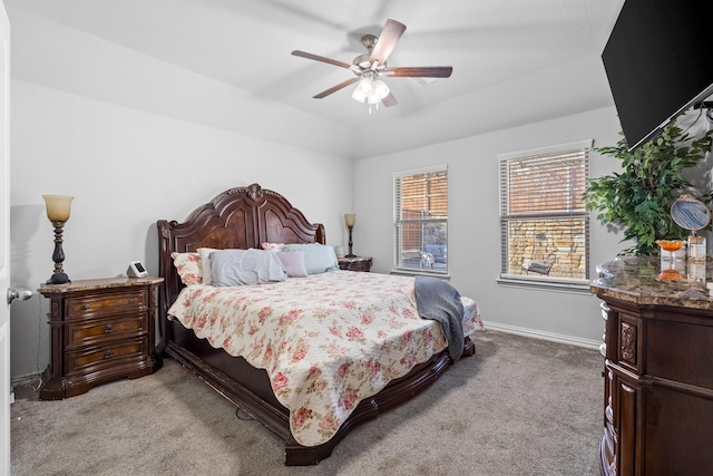 bedroom featuring vaulted ceiling, light carpet, and ceiling fan