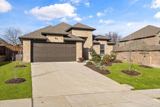 view of front of property featuring a garage and a front yard