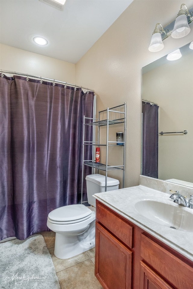 bathroom with tile patterned floors, toilet, and vanity