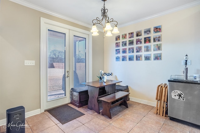 dining room with light tile patterned floors, crown molding, and french doors