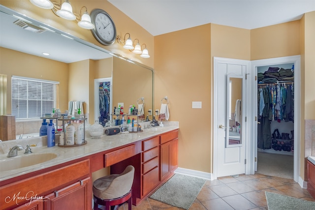 bathroom with vanity, a bath, and tile patterned flooring