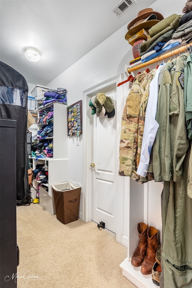 walk in closet featuring carpet floors