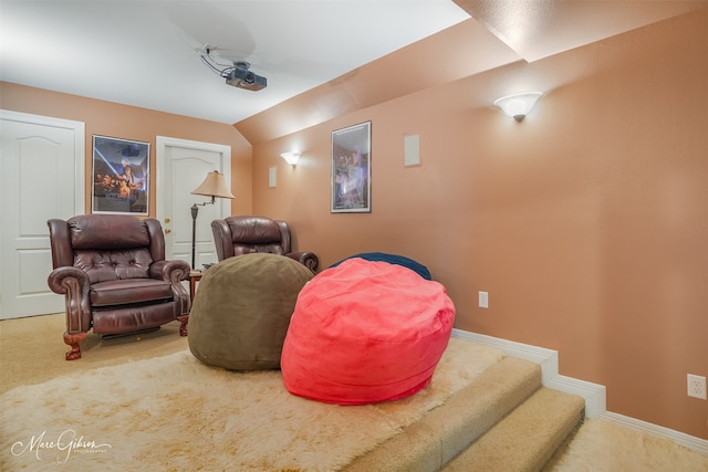 home theater room with vaulted ceiling and carpet