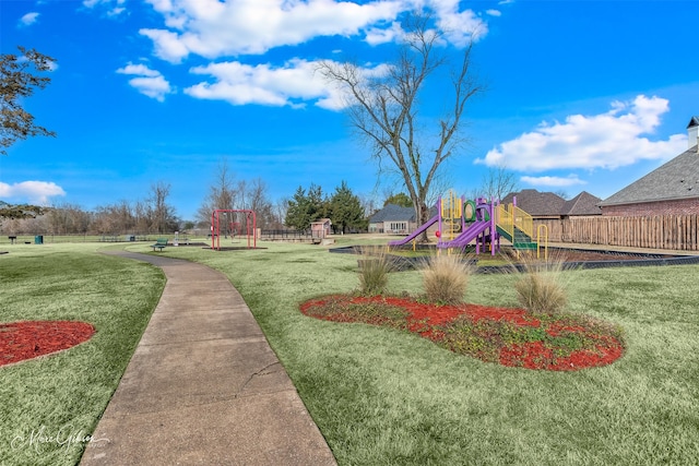 view of property's community featuring a playground and a lawn