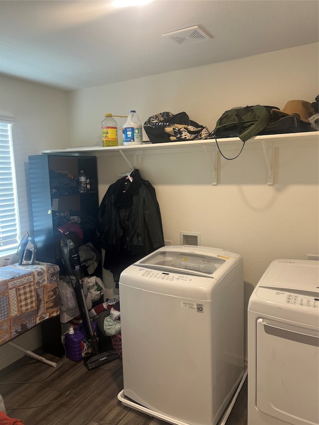 laundry area featuring dark hardwood / wood-style flooring and washer and dryer