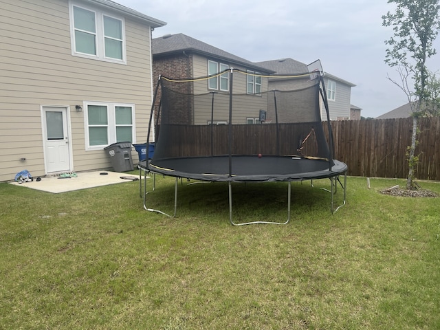 view of yard with a patio and a trampoline