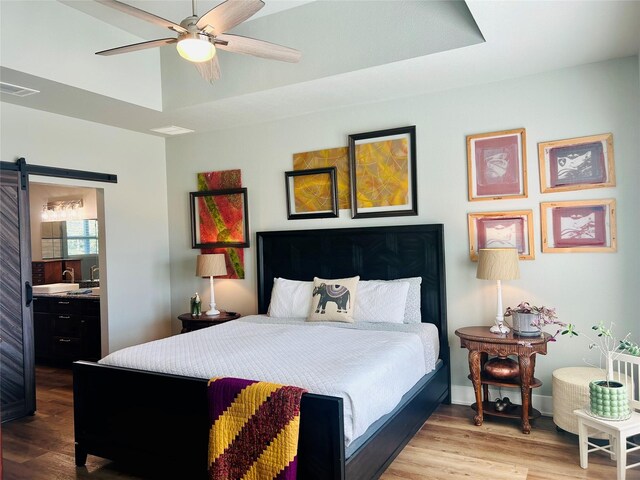 bedroom featuring hardwood / wood-style flooring and a raised ceiling