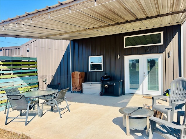 view of patio / terrace featuring an outdoor fire pit and french doors