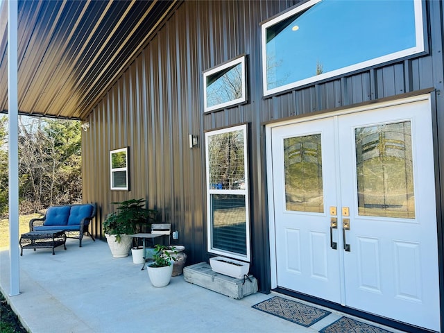 entrance to property featuring board and batten siding and french doors