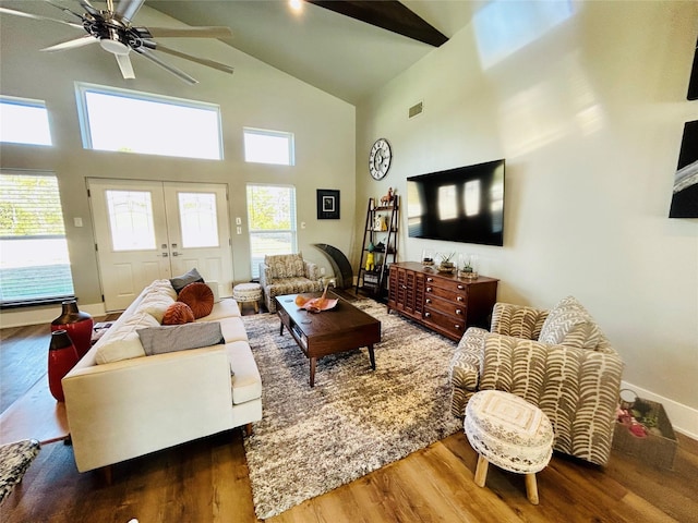 living area with visible vents, ceiling fan, wood finished floors, french doors, and high vaulted ceiling