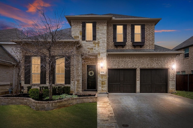 view of front of home with stone siding, roof with shingles, concrete driveway, an attached garage, and brick siding