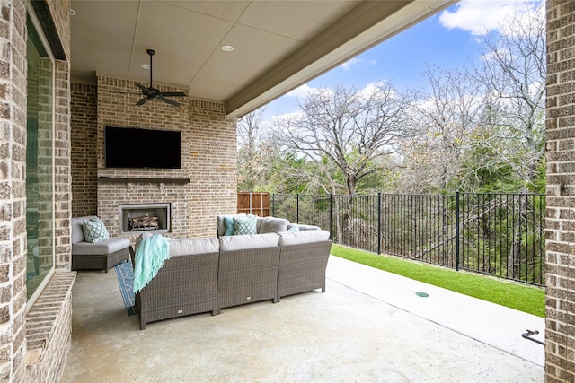 view of patio with an outdoor living space with a fireplace and ceiling fan