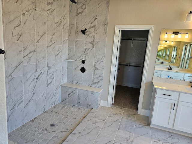 bathroom with vanity and a tile shower